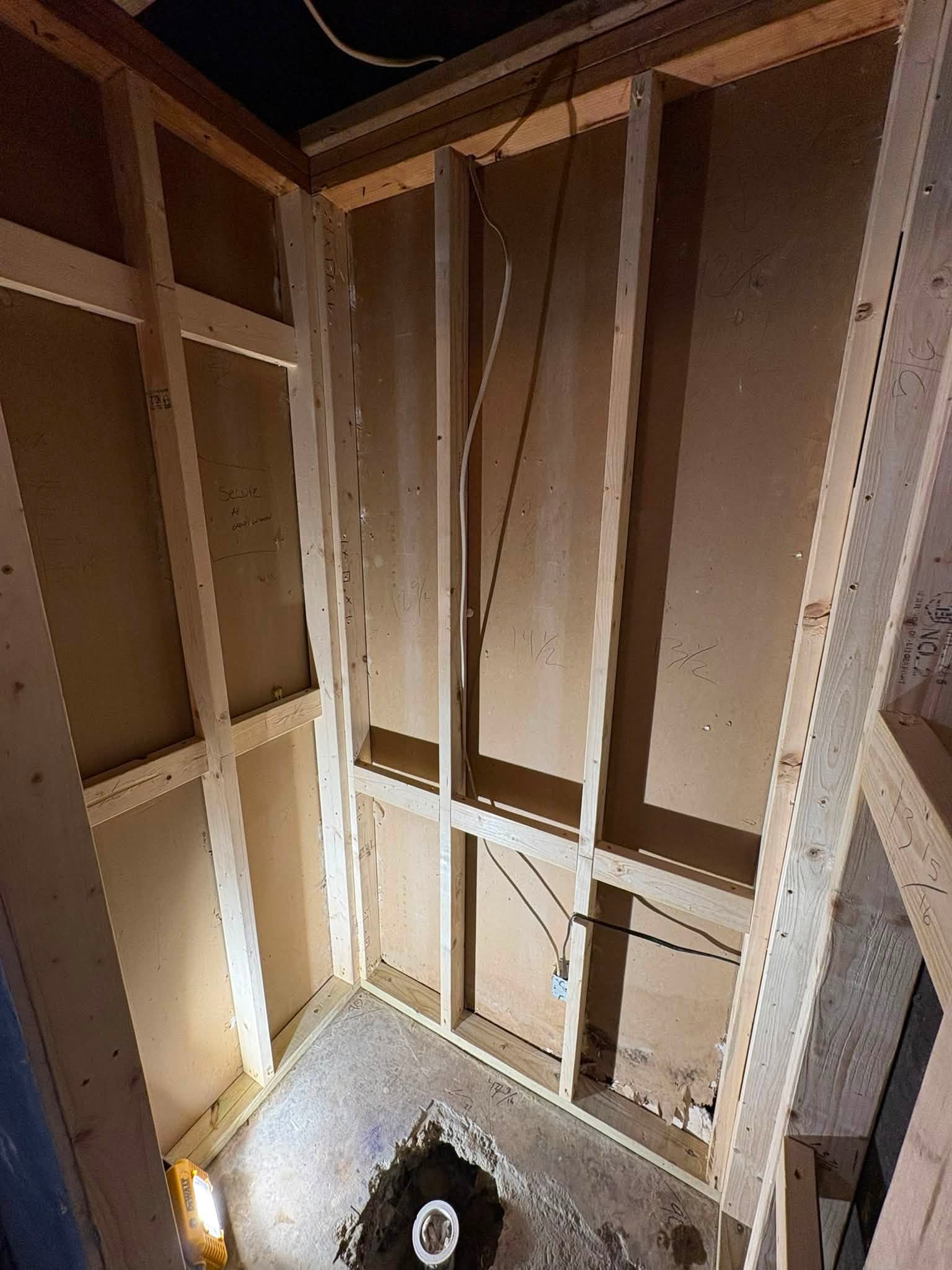 Rebuilt wall and shower framing after the damaged material was removed