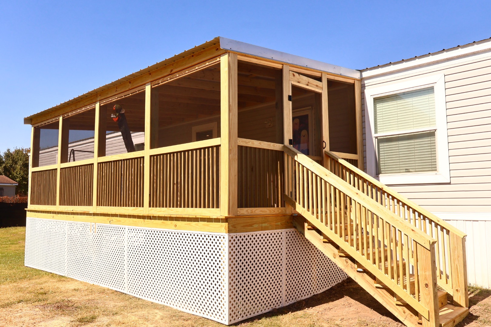 Completed screened porch with a custom deck, stairs, and railing